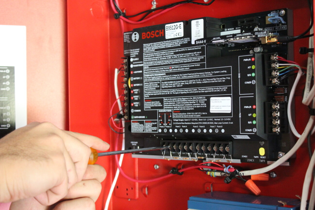 technician working on security alarm