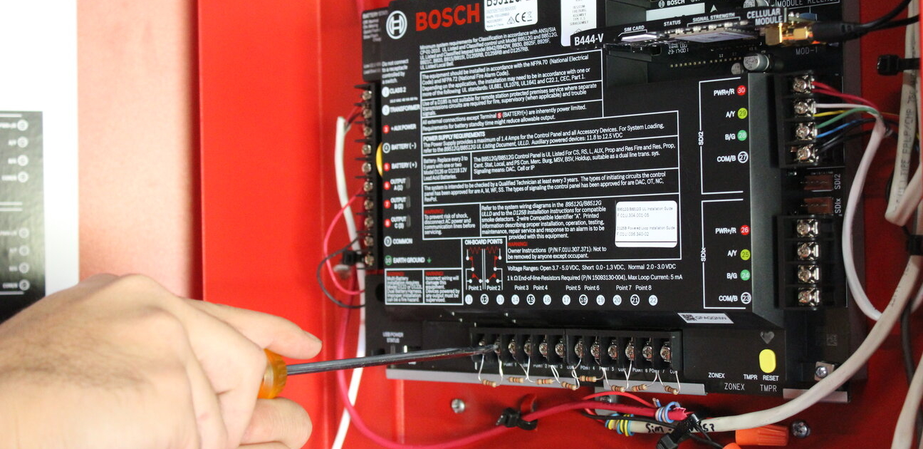 technician working on security alarm