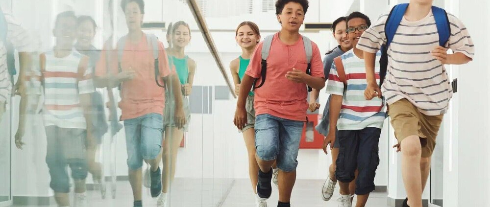 School children running through a hallway