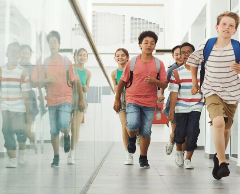 School children running through a hallway