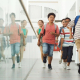 School children running through a hallway