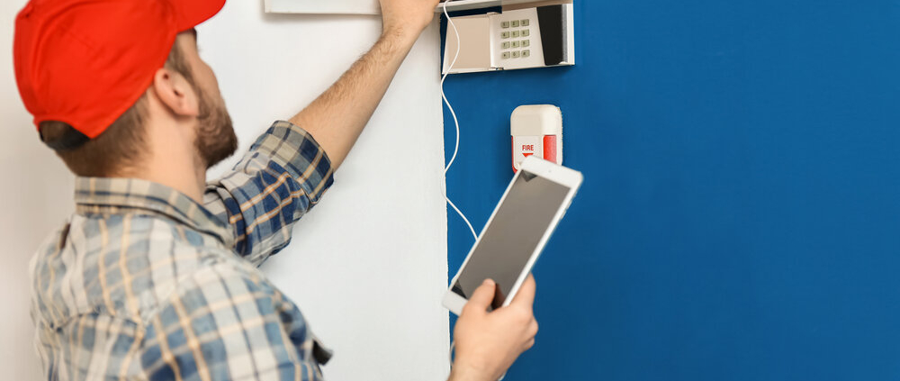 Technician conducting fire alarm system inspection