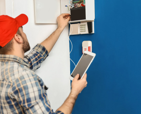 Technician conducting fire alarm system inspection