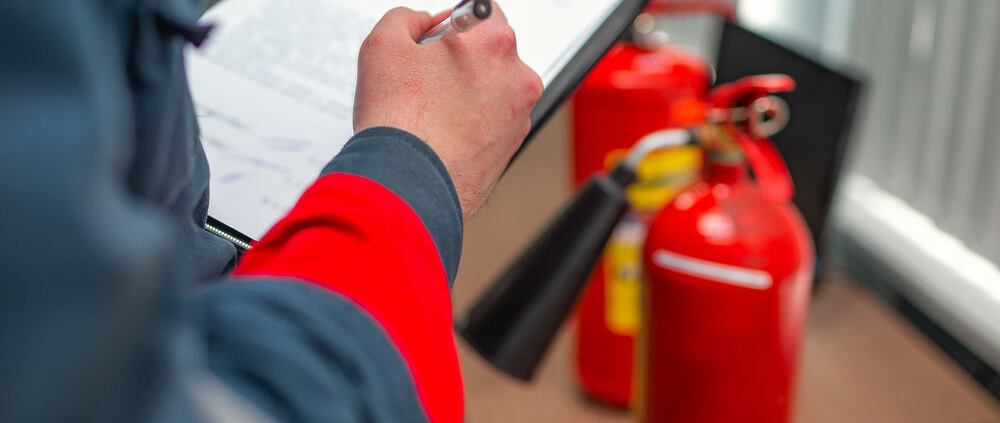 Fire Safety Professional Inspecting A Fire Extinguisher