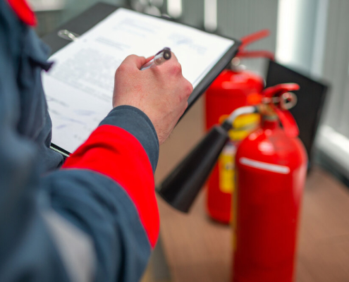 Fire Safety Professional Inspecting A Fire Extinguisher