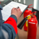 Fire Safety Professional Inspecting A Fire Extinguisher